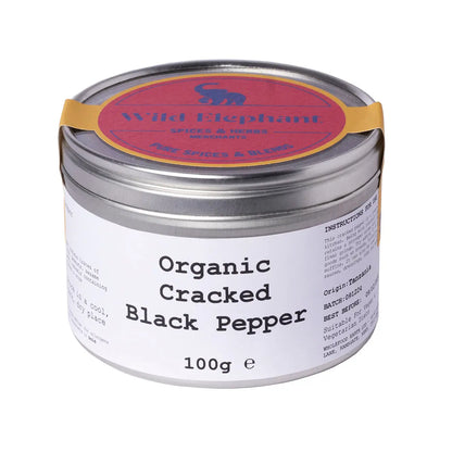 Organic cracked black pepper from Wild Elephant, Whole Food Earth Herbs & Spices, close-up of freshly ground black peppercorns.