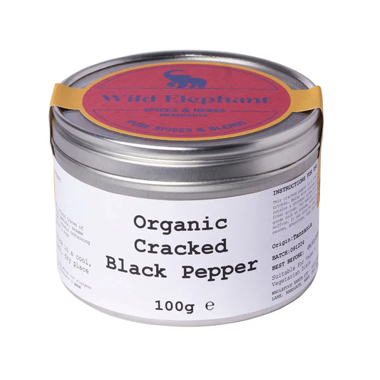 Organic cracked black pepper from Wild Elephant, Whole Food Earth Herbs & Spices, close-up of freshly ground black peppercorns.