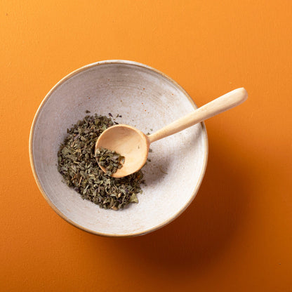 Organic dried basil from Whole Food Earth, wild-harvested herb in a 75g package, showing fresh green dried basil leaves.