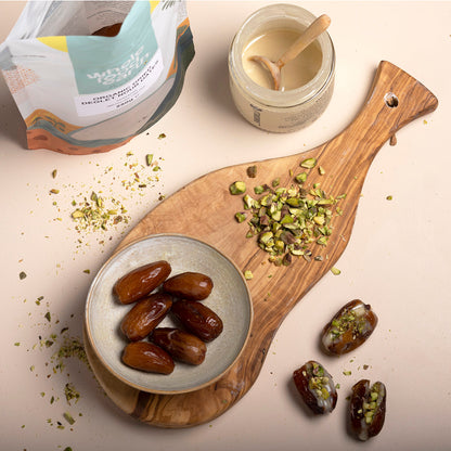 Organic Deglet Nour dates from Whole Food Earth, pitted dried fruit, shown in a natural setting with a bowl of dates and fresh leaves.