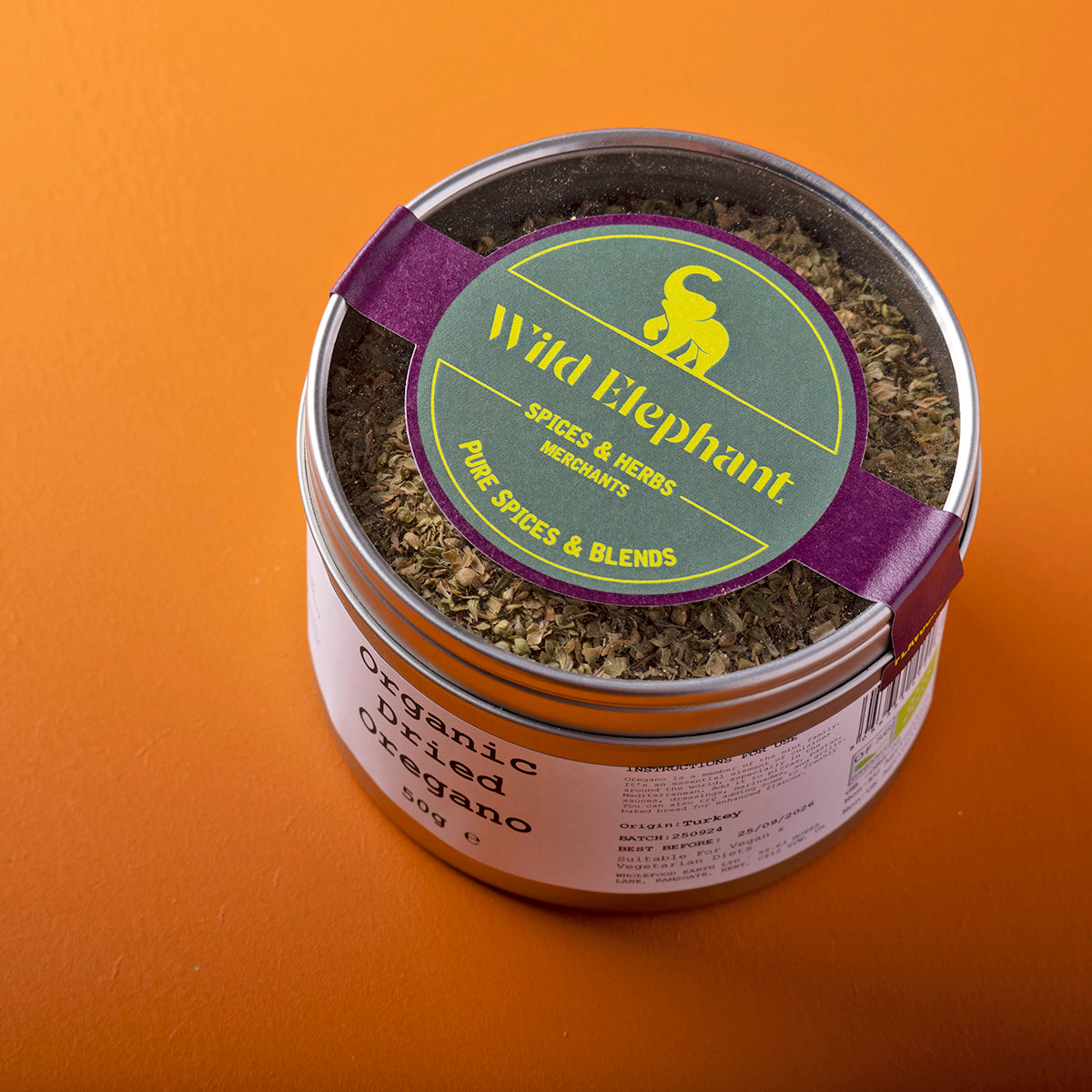 Organic dried oregano from Wild Elephant, a Whole Food Earth herb and spice, shown in a 50g package with fresh leaves and dried herbs.