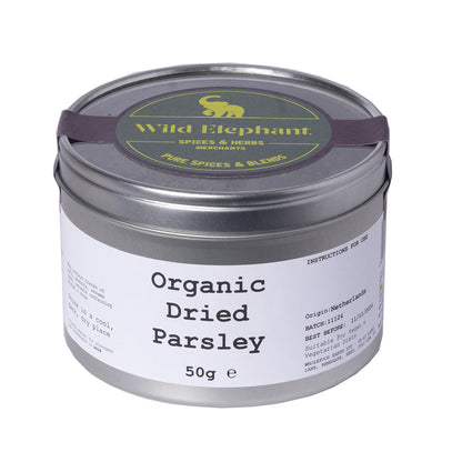 Whole Food Earth organic dried parsley from wild elephant, 50g, in a clear glass jar showing vibrant green herb leaves.