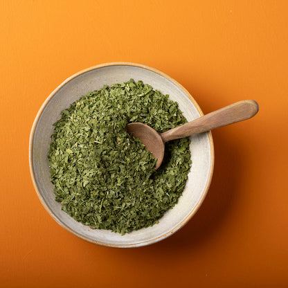Organic dried parsley from Wild Elephant, 50g, in a clear jar, showing vibrant green herb leaves for culinary seasoning.