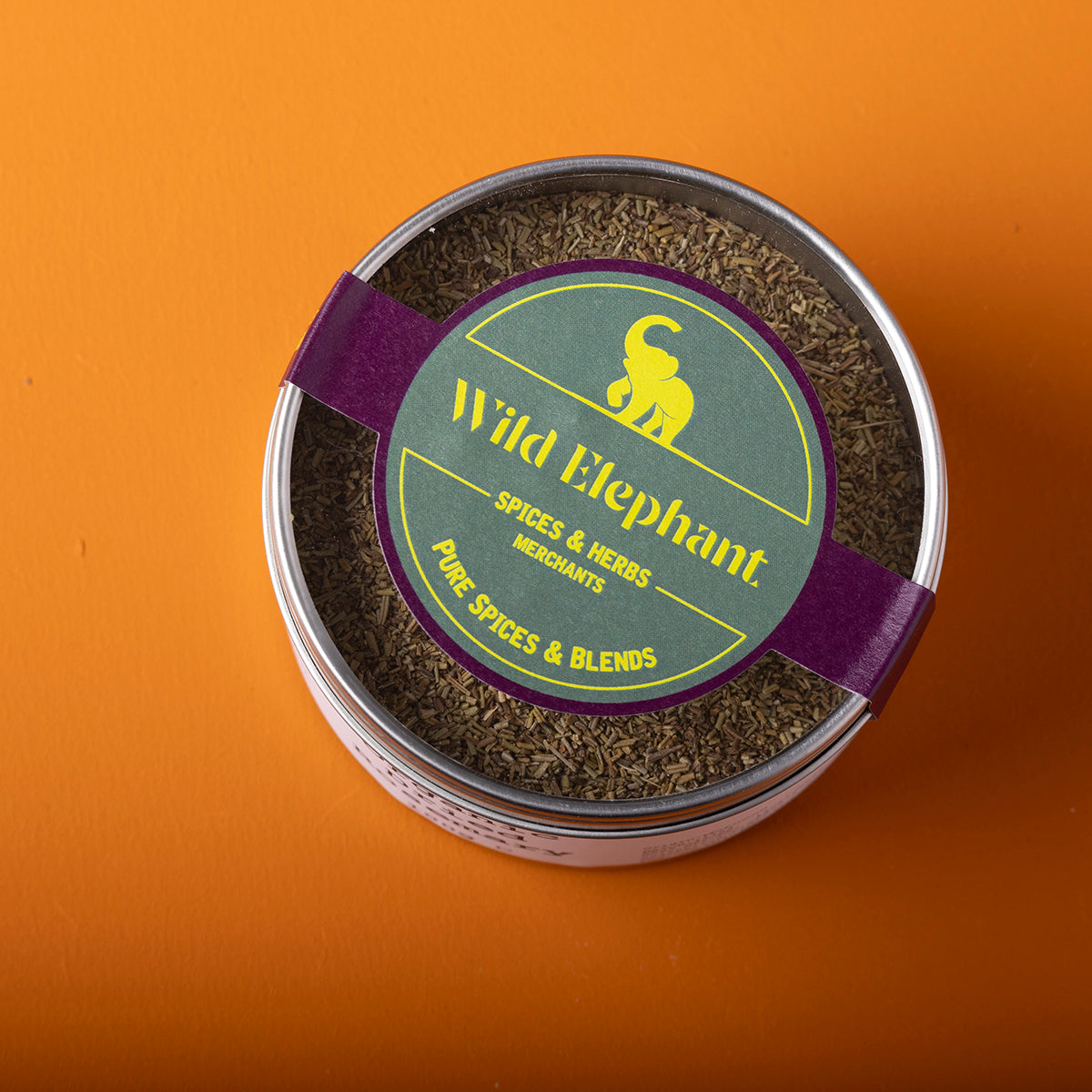 Organic dried rosemary from Wild Elephant, 100g, herbs and spices with needle-like green leaves on a rustic background.