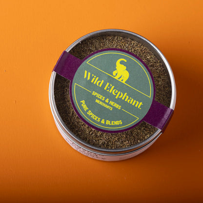 Organic dried rosemary from Wild Elephant, 100g, herbs and spices with needle-like green leaves on a rustic background.