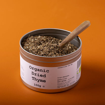 Organic dried thyme herb from Whole Food Earth, showing fresh green sprigs of wild thyme in a 100g package.
