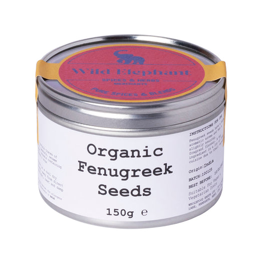 Organic fenugreek seeds in a clear glass jar, from Whole Food Earth, showing small, golden-brown herb seeds on a white background.