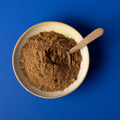 Organic Garam Masala from Wild Elephant, a 100g jar of herbs and spices with colorful spice blend in a glass jar.