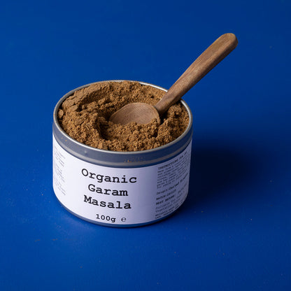 Organic Garam Masala spice blend from Wild Elephant, featuring a colorful mix of herbs and spices in a 100g package.