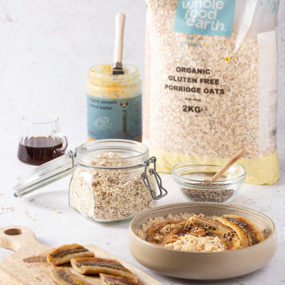 Whole Food Earth organic gluten-free porridge oats in a bowl with milk and fresh berries, ready for breakfast.
