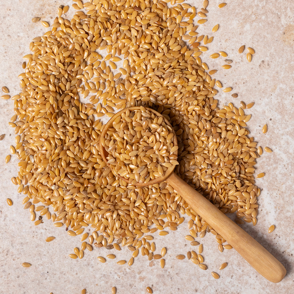 Organic golden flaxseed, Whole Food Earth brand, close-up of raw, whole golden linseeds in a bowl for healthy beans and pulses.