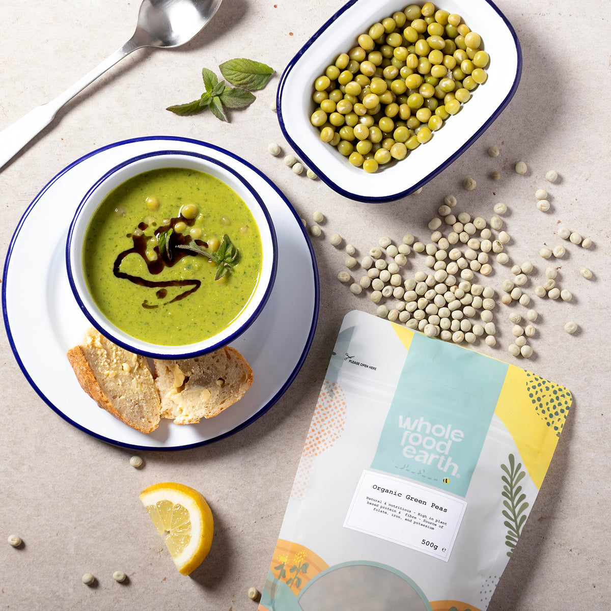 Fresh organic green peas in a bowl on a rustic wooden table, showcasing Whole Food Earth beans and pulses.