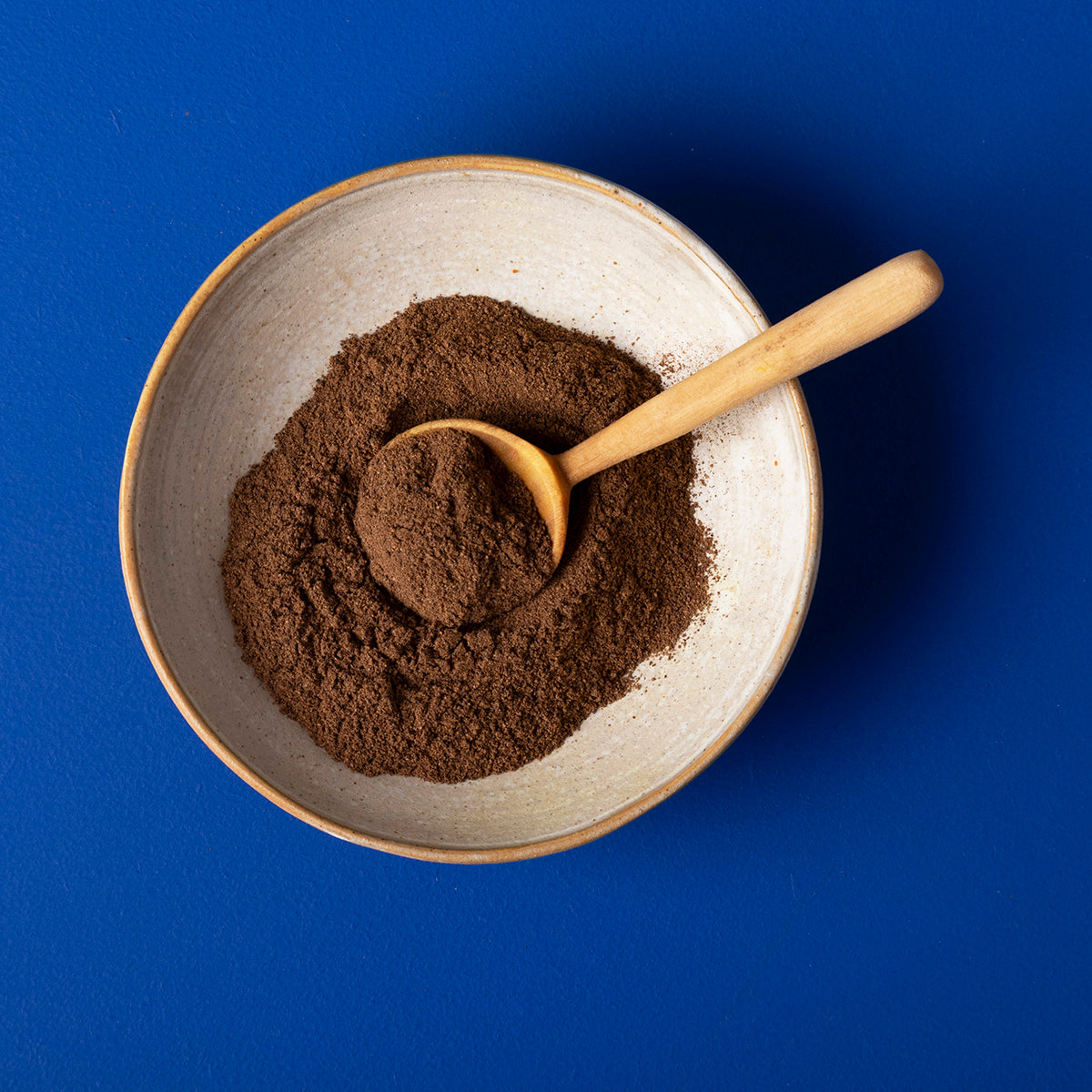 Organic ground allspice from Whole Food Earth, wild-harvested spice in a 100g package, showing the spice's rich brown color.
