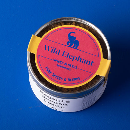 Organic ground cumin from Whole Food Earth, Wild Elephant brand, in a 100g package, showing the spice's fine brown powder.