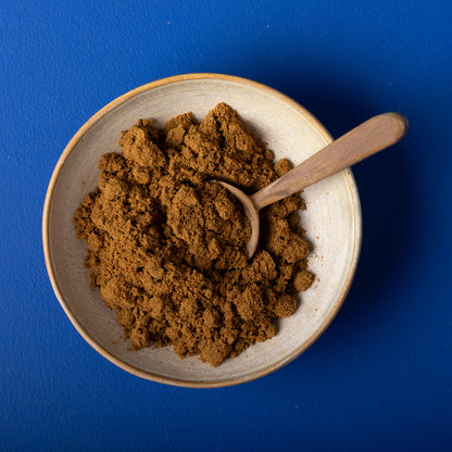 Organic ground cumin from Wild Elephant, 100g, in a clear spice jar, showcasing rich brown cumin powder on a white background.