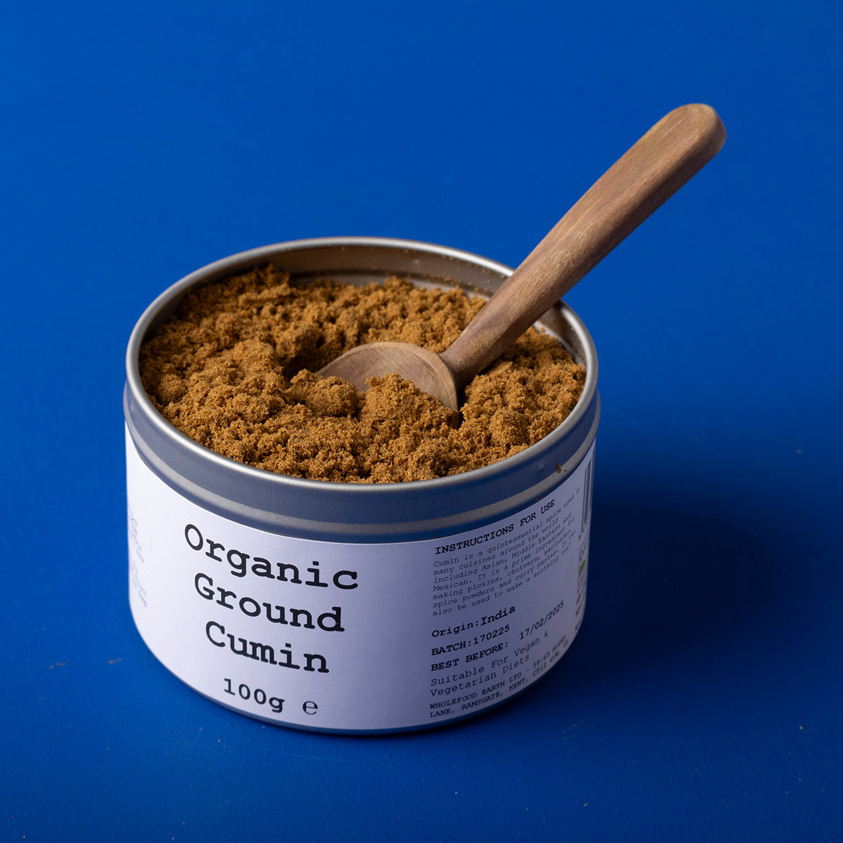 Organic ground cumin spice from Wild Elephant, 100g, in a clear jar, showcasing the rich brown powder of herbs and spices.