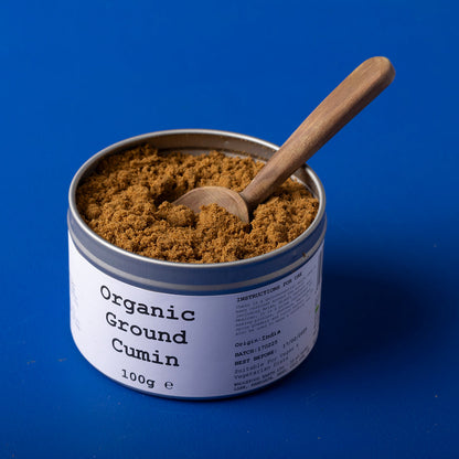 Organic ground cumin spice from Wild Elephant, 100g, in a clear jar, showcasing the rich brown powder of herbs and spices.