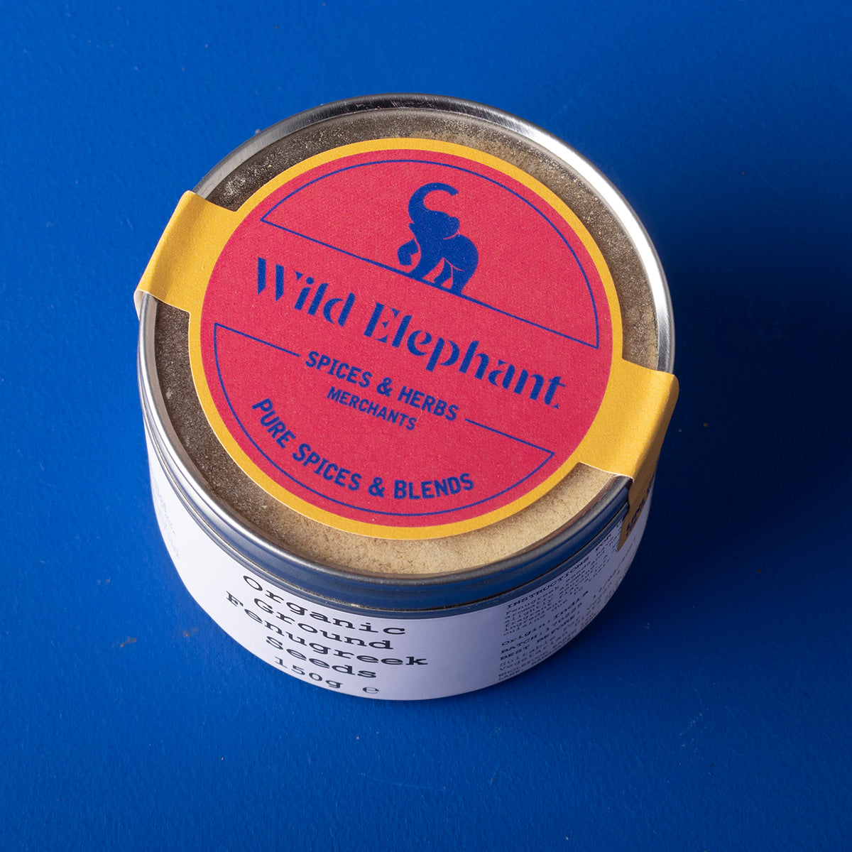 Organic ground fenugreek seeds from Wild Elephant, 150g, shown in a clear container, fresh and aromatic herbs and spices.