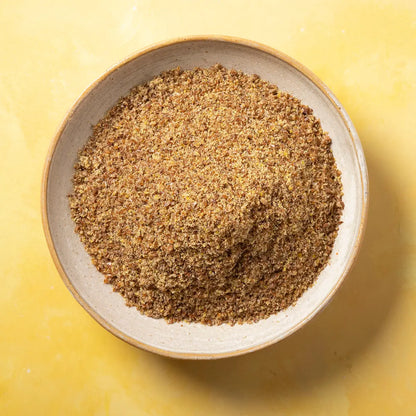 Organic ground flaxseed from Whole Food Earth, a natural organic ground linseed in a clear container.