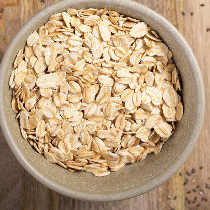 Organic jumbo oats cereal from Whole Food Earth, showing a close-up of large, golden oat flakes on a white background.