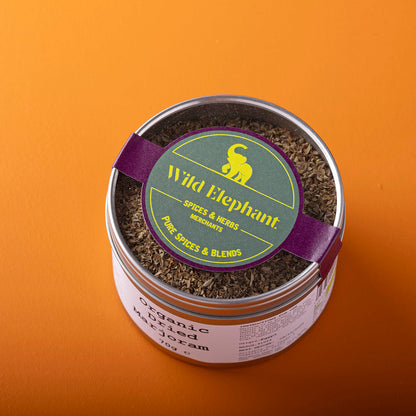 Organic dried marjoram herbs from Whole Food Earth, wild-harvested, in a 70g package, with fresh green leaves and herbs.