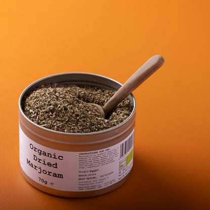 Organic dried marjoram herb from Whole Food Earth, 70g, showing fresh green leaves and dried herb in a clear container.