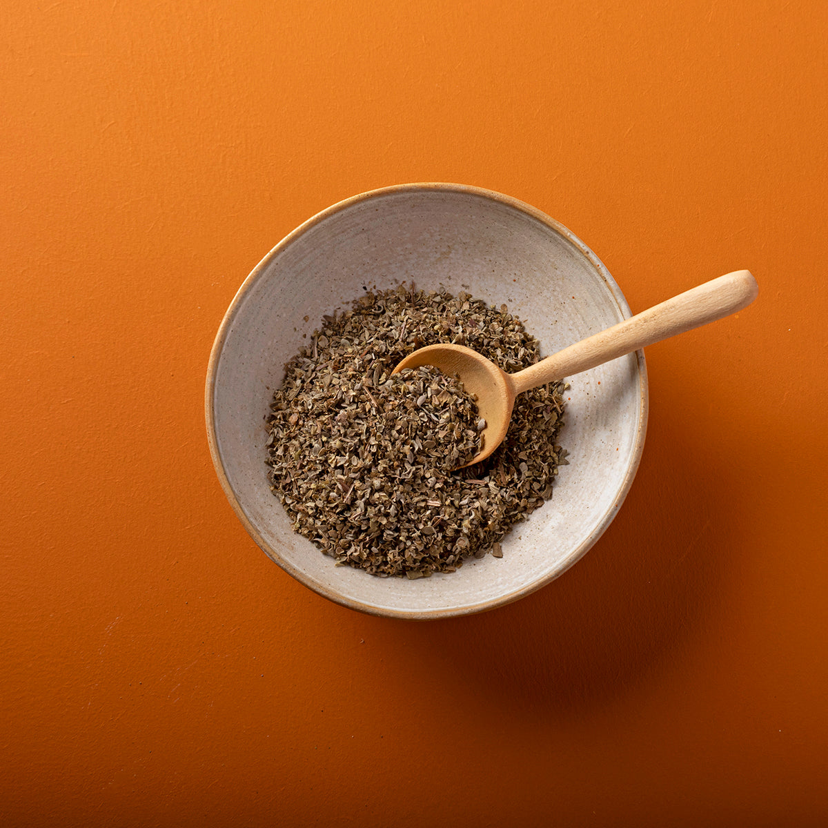 Organic dried marjoram herb from Whole Food Earth, shown in a 70g package, with fresh green leaves and dried herb.