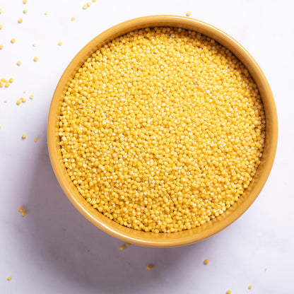 Organic millet grain from Whole Food Earth, showing small, round, light-colored millet grains in a clear bowl.