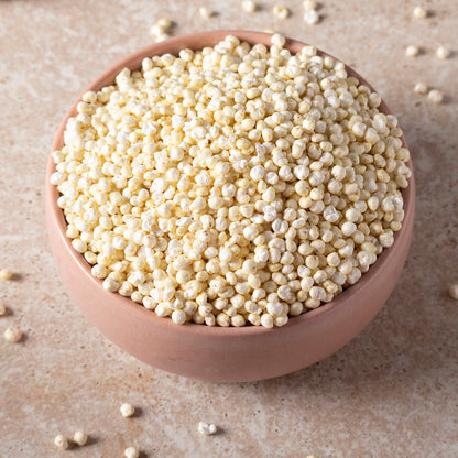 Organic millet puffs from Whole Food Earth, showing a bowl of crispy, golden millet cereal grains on a neutral background.