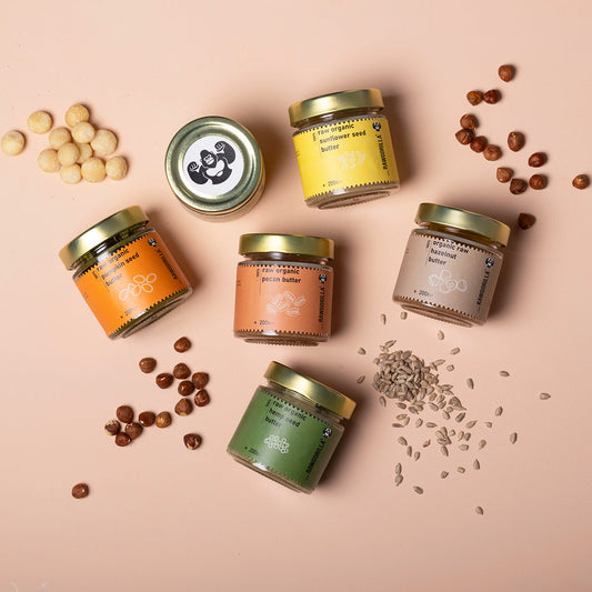 Assorted organic nut and seed butters in a selection box from Whole Food Earth, featuring various jar labels and natural packaging.