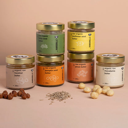 Assorted organic nut and seed butters in a selection box from Whole Food Earth, showing various jars with labels and nut spreads.