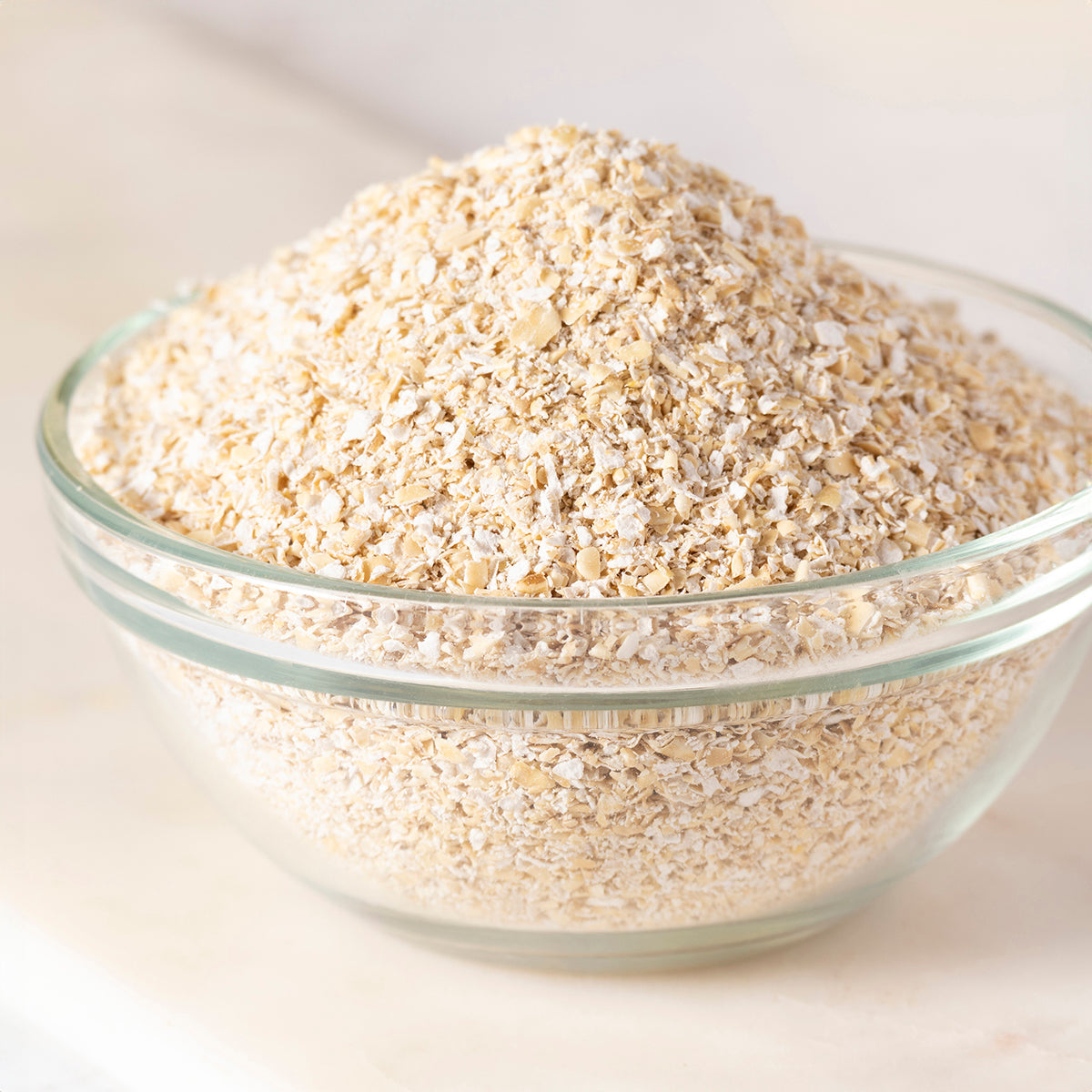 Organic oat bran cereal from Whole Food Earth, close-up of the natural, textured oat bran in a bowl on a wooden background.