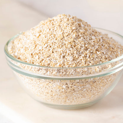 Organic oat bran cereal from Whole Food Earth, close-up of the natural, textured oat bran in a bowl on a wooden background.