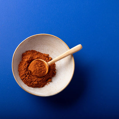 Organic paprika powder from Wild Elephant, a vibrant red spice in a clear jar, part of Whole Food Earth's herbs and spices collection.