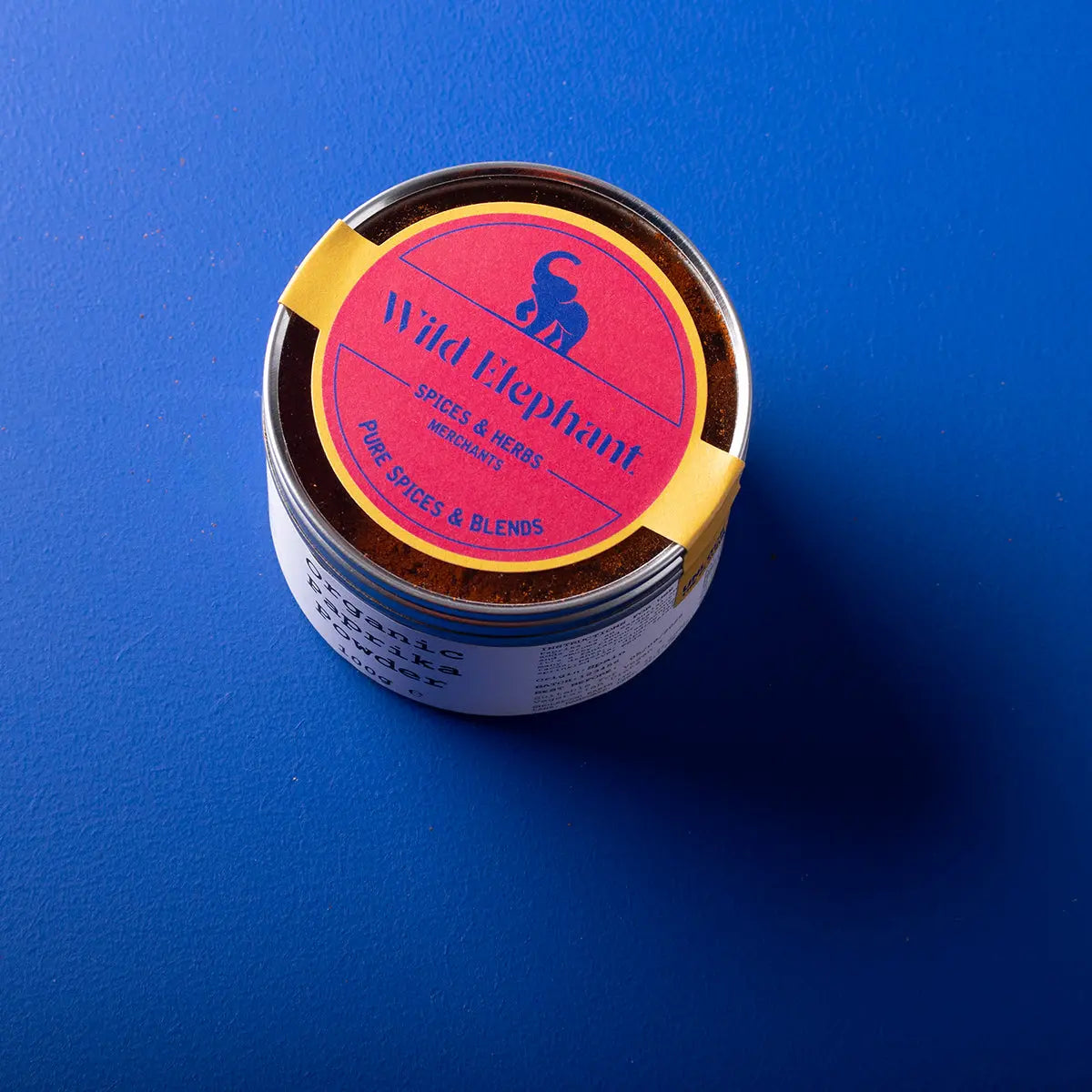 Organic paprika powder from Wild Elephant, a vibrant red herbs and spices product by Whole Food Earth, shown in a close-up image.