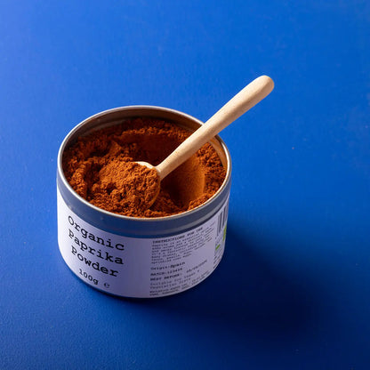 Organic paprika powder from Whole Food Earth, a vibrant red herb and spice with fine, ground texture for cooking and seasoning.