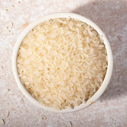 Organic parboiled long white rice from Whole Food Earth, showing clean, uncooked grains in a close-up image.