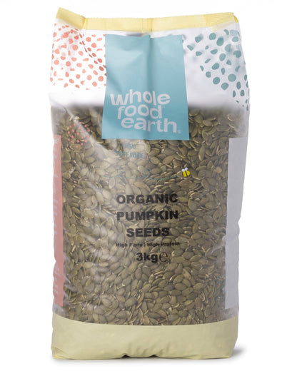 Organic pumpkin seeds from Whole Food Earth, displayed in a bowl, showcasing their green shells and natural texture.