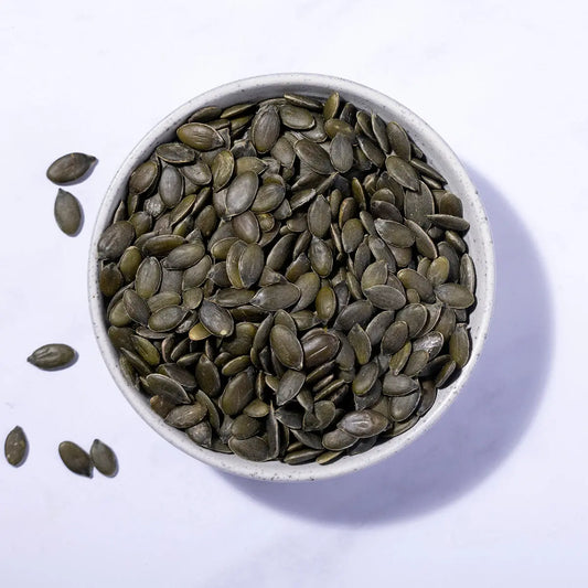Organic pumpkin seeds from Whole Food Earth, showing a close-up of raw, green pumpkin seeds in a bowl.