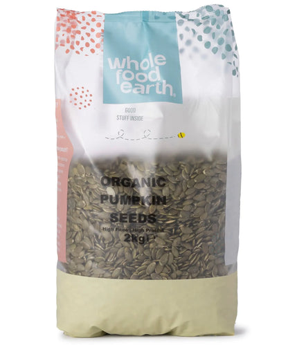 Organic pumpkin seeds from Whole Food Earth, small green seeds in a clear bowl, displayed as a nutritious nuts and seeds product.