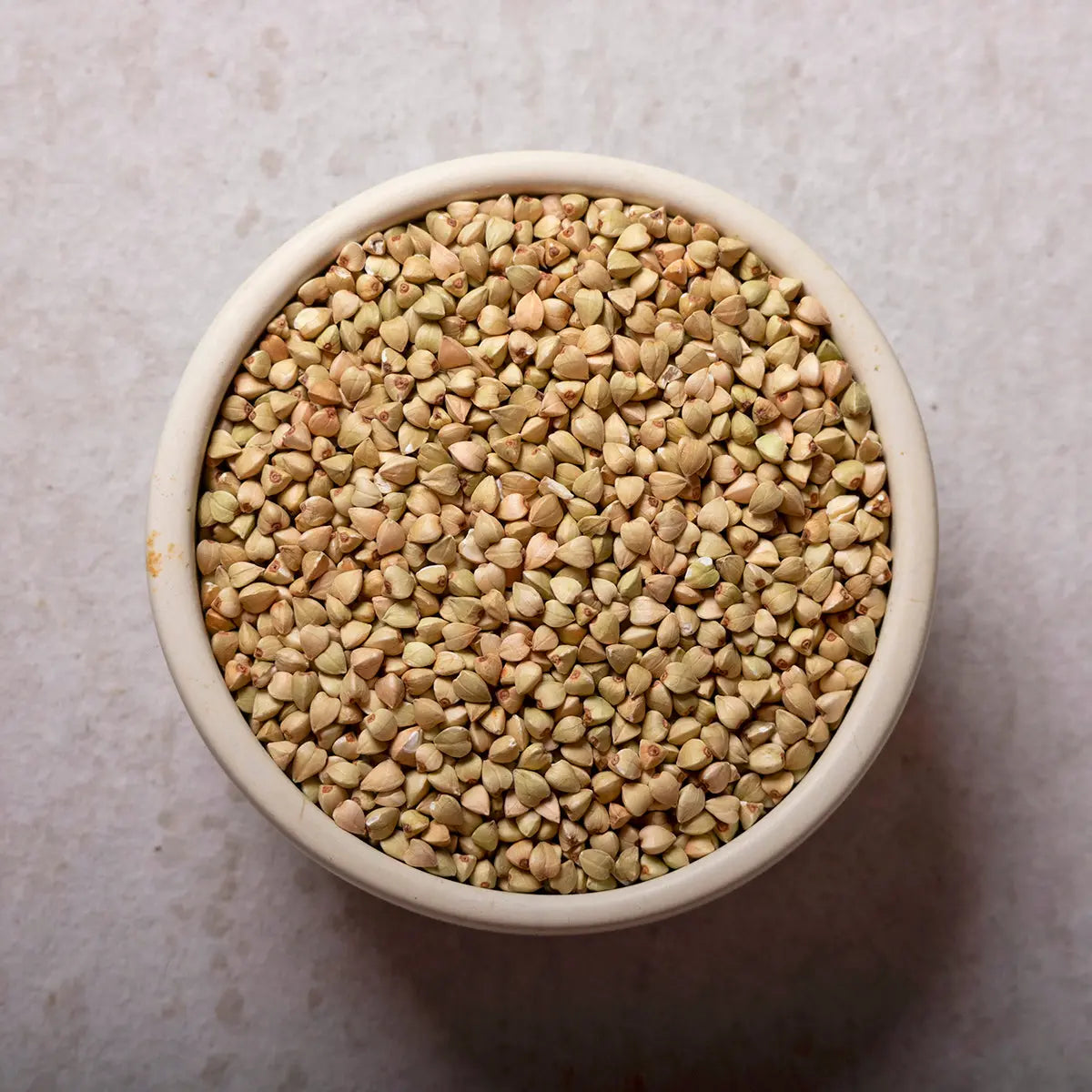 Raw organic buckwheat grains from Whole Food Earth, showcasing natural, unprocessed buckwheat in a clear view.