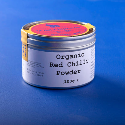 Organic red chili powder from Wild Elephant, 100g, in a spice jar, showcasing vibrant red chili powder for herbs and spices.