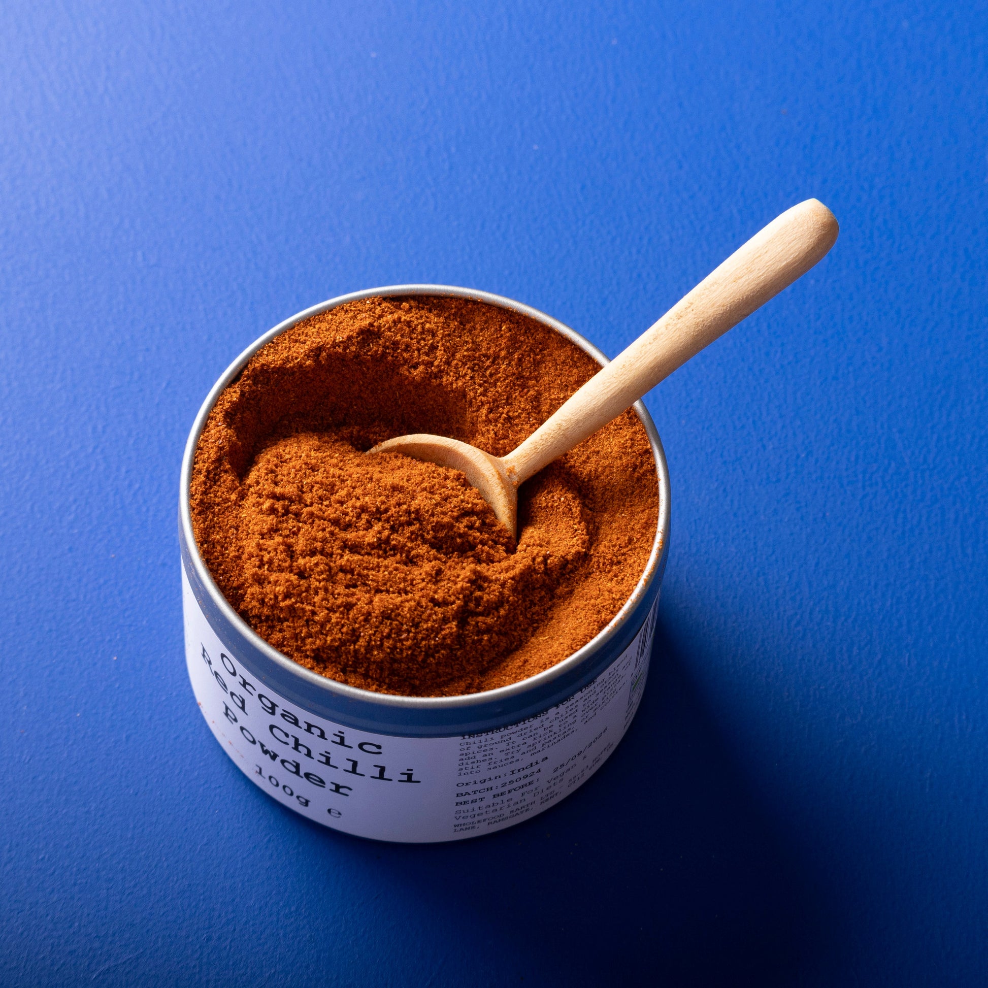 Organic red chilli powder from Wild Elephant in a 100g package, shown in a clear, resealable spice jar.