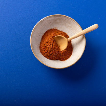 Organic red chilli powder from Wild Elephant in a 100g package, showcasing vibrant red chili powder in a natural herbs and spices setting.
