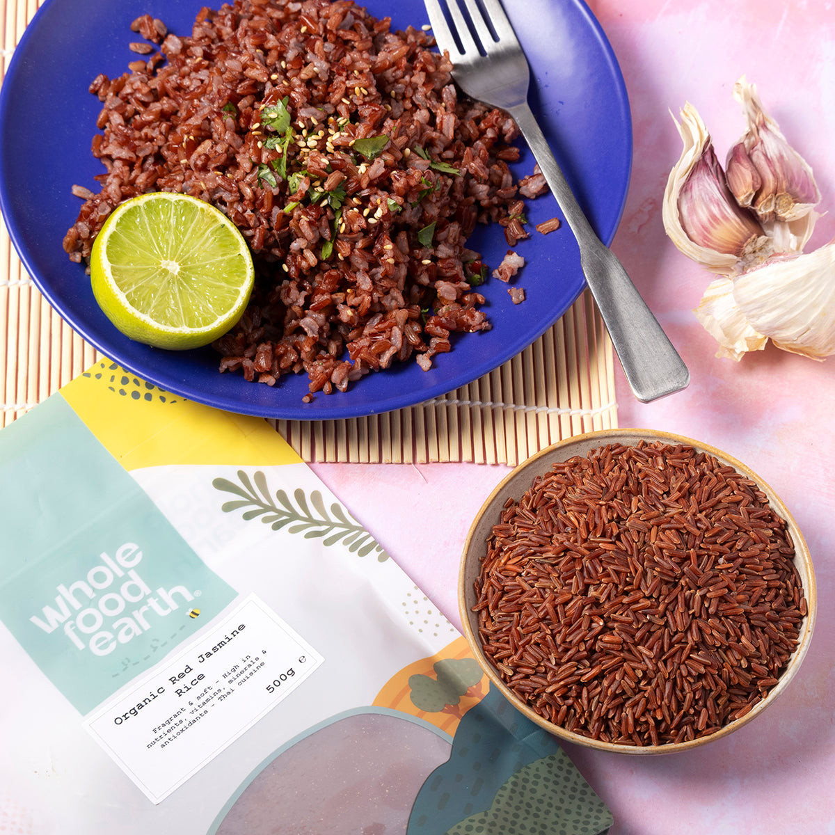 Organic Red Jasmine Rice from Whole Food Earth in a bowl, showcasing vibrant red grains on a rustic wooden background.