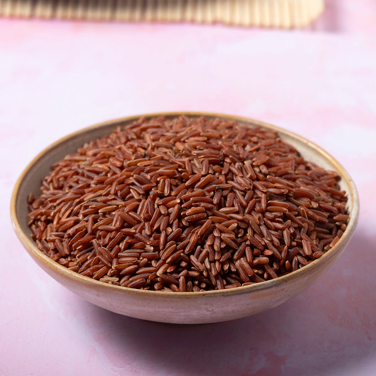 Organic red jasmine rice grains from Whole Food Earth, showcasing the vibrant red rice variety in a close-up image.