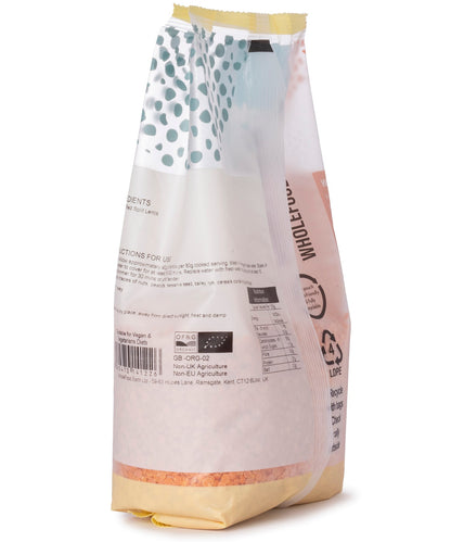 Organic red split lentils from Whole Food Earth in a clear plastic bag, showing vibrant orange-red pulses ready for cooking.