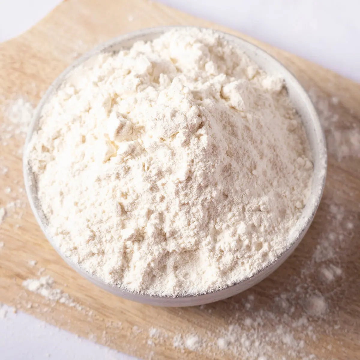 Organic self-raising white flour from Serious Grains by Whole Food Earth, shown in a clear bag with the flour inside.