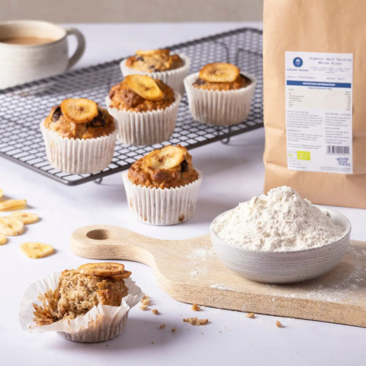 Organic Self Raising White Flour by Whole Food Earth, in a kitchen setting, showing a bag of organic flour on a countertop.