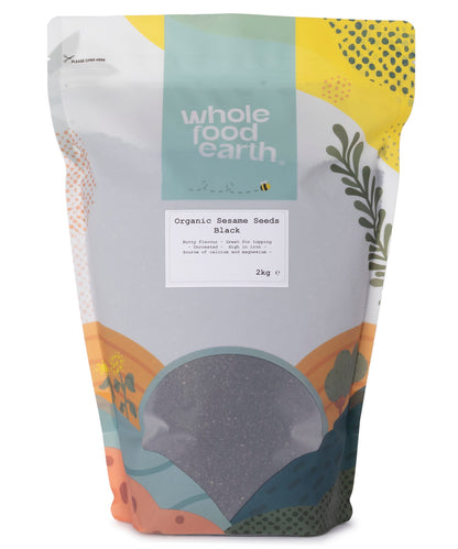 Black organic sesame seeds in a clear plastic bag, showcasing small, shiny seeds from Whole Food Earth.